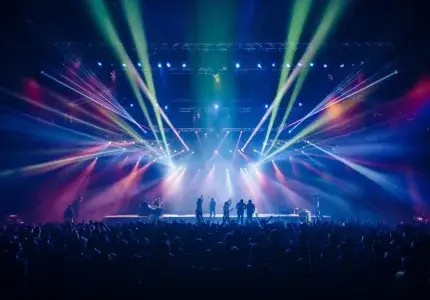 thousands of people watching a concert at night